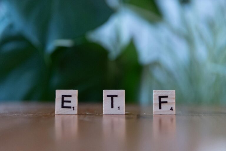 scrabble tiles spelling etf on wooden table